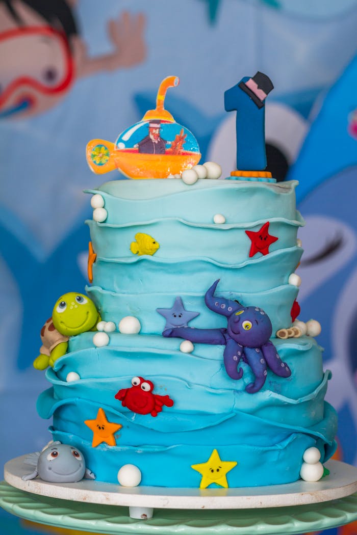 Vibrant under the sea cake with ocean creatures for a kids first birthday.