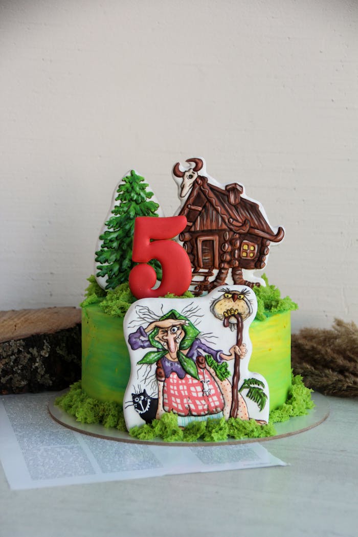 Colorful witch-themed birthday cake with decorations, perfect for kids celebrating a milestone.